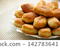 Stack of golden fried pirozhki pies served on plate for bakery design 142783641