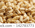 Dry organic textured pea protein pieces. Plant-based food has an porous structure and elongated shapes with a rough fibrous texture 142783773