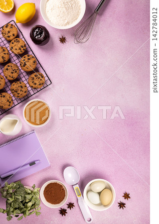 Baking chocolate chip cookies with ingredients on pink background Baking chocolate chip cookies with ingredients on pink background 142784012