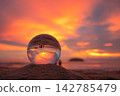 view of beautiful nature at the beach inside crystal ball. 142785479