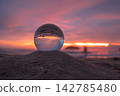view of beautiful nature at the beach inside crystal ball. 142785480