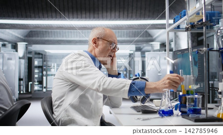 Aged male scientist being impatient while waiting for experiment data, reflecting agitation and curiosity during advanced medical research in genetics. Engaged in a study. Aged male scientist being impatient while waiting for experiment data, reflecting agitation and curiosity during advanced medical research in genetics. Engaged in a study. 142785946