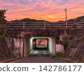 Underpass and road in the mountains, bathed in the sunset light 142786177