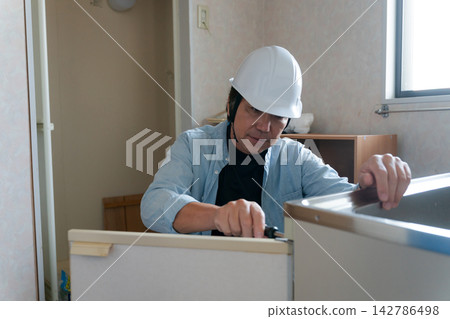 一名男工人正在裝修廚房。 一名男工人正在裝修廚房。 142786498