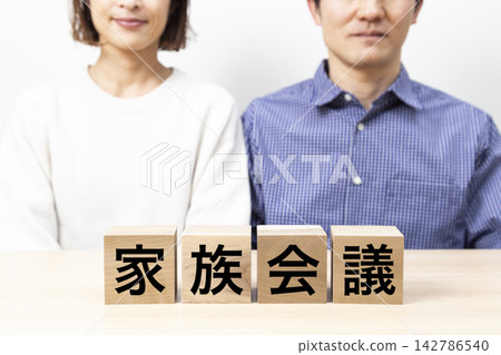 A block labeled "Family Meeting" and a middle-aged couple. A block labeled "Family Meeting" and a middle-aged couple. 142786540