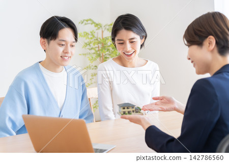 一對正在考慮買房的夫婦和一位房地產經紀人 142786560