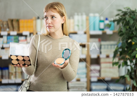 Young woman chooses cosmetics at pharmacy Young woman chooses cosmetics at pharmacy 142787033