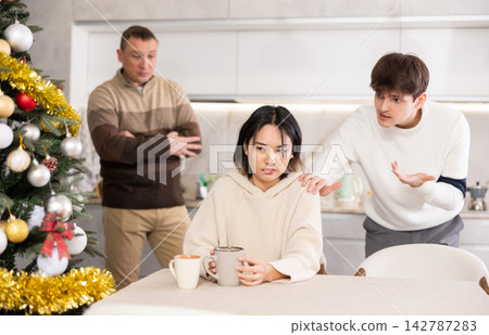 Adult and young man quarreling with young woman Adult and young man quarreling with young woman 142787283