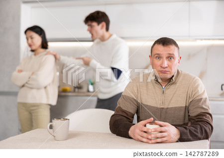 Adult man sad during family quarrel 142787289