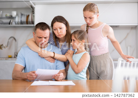 Woman with husband carefully reads sad news in financial family business report at home Woman with husband carefully reads sad news in financial family business report at home 142787362