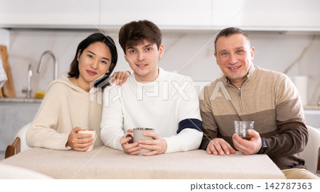 Portrait of happy family - married couple and father at home Portrait of happy family - married couple and father at home 142787363