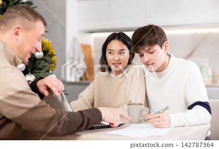 Couple young woman and guy discussing deal with agent Couple young woman and guy discussing deal with agent 142787364