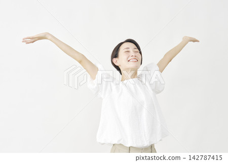 Middle-aged woman taking a deep breath against a white background. Middle-aged woman taking a deep breath against a white background. 142787415