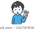 A young man in casual clothes is making a gesture by holding up three fingers. 142787656
