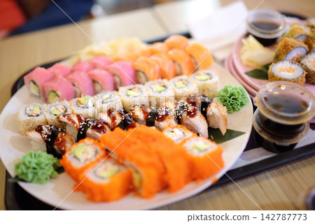 A platter with a magnificent set of sushi and rolls at a Japanese restaurant. A platter with a magnificent set of sushi and rolls at a Japanese restaurant. 142787773