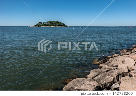 Distant view of Falkner Island across Long Island Sound from the Guilford shoreline in Connecticut Distant view of Falkner Island across Long Island Sound from the Guilford shoreline in Connecticut 142788200
