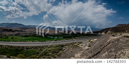 Wide valley highway and dramatic clouds along the road to Bishkek Kyrgyzstan Wide valley highway and dramatic clouds along the road to Bishkek Kyrgyzstan 142788303