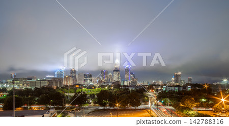 Illuminated Charlotte skyline under low clouds at night Illuminated Charlotte skyline under low clouds at night 142788316
