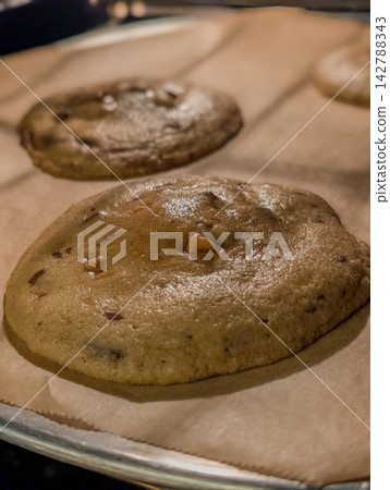 Sourdough chocolate chip cookies cooling on baking sheet Sourdough chocolate chip cookies cooling on baking sheet 142788343