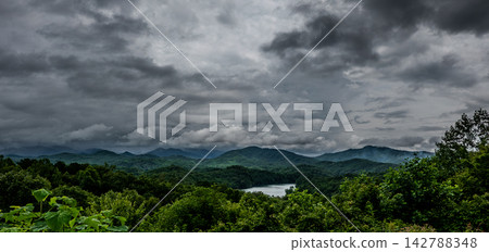 Lake Fontana and rolling mountain ridges under a heavy stormy sky North Carolina Lake Fontana and rolling mountain ridges under a heavy stormy sky North Carolina 142788348