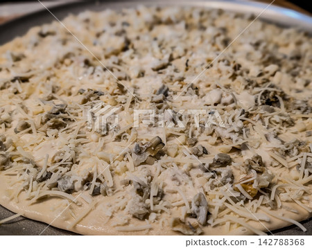 Uncooked white clam pie pizza on metal pan Uncooked white clam pie pizza on metal pan 142788368