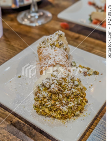 Fresh Italian cannoli dessert with crushed pistachios Fresh Italian cannoli dessert with crushed pistachios 142788378