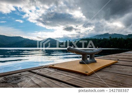 Boat dock cleat with mountain lake view and dramatic sky Lake Santeetlah North Carolina Boat dock cleat with mountain lake view and dramatic sky Lake Santeetlah North Carolina 142788387