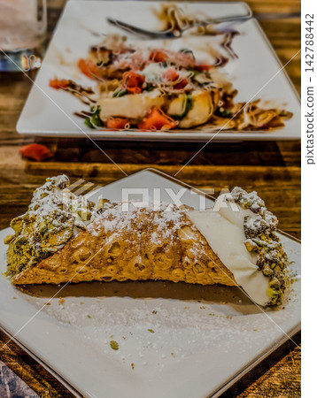 Fresh Italian cannoli dessert with crushed pistachios Fresh Italian cannoli dessert with crushed pistachios 142788442