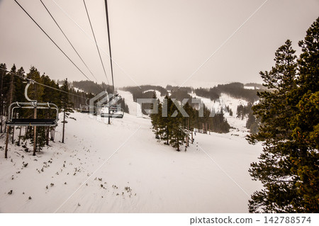 Breckenridge Ski Resort Colorado Snow Covered Terrain Park and Mountain Lodge Buildings in Winter Snowfall with Overcast Conditions Breckenridge Ski Resort Colorado Snow Covered Terrain Park and Mountain Lodge Buildings in Winter Snowfall with Overcast Conditions 142788574