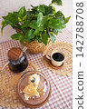 A Cozy Morning Scene Featuring Coffee, Cake, and Lush Greenery in a Warm Atmosphere 142788708