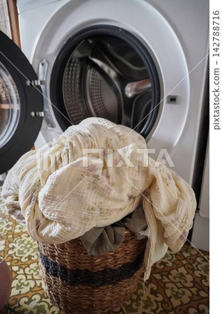 Laundry Routine: Washing a Pile of Clothes in Front of an Open Washing Machine Door Laundry Routine: Washing a Pile of Clothes in Front of an Open Washing Machine Door 142788716