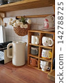 Charming Kitchen Scene Featuring Teapot, Mugs, and Decorative Elements for a Cozy Atmosphere 142788725