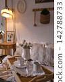 Cozy Indoor Space Featuring Wooden Tray with White Cups and Fresh Flowers in a Relaxed Atmosphere 142788733