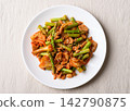 Stir fried asparagus with kimchi cabbage and pork on white plate, Korean style, top view 142790875