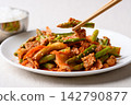 Stir fried asparagus with kimchi cabbage and pork eating by chopsticks, Korean style 142790877