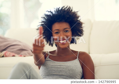 Black woman, portrait and happy in home with thumbs up for relax, yes to self care and approval on floor of lounge. Girl, smile and hand gesture for agreement, thank you and satisfaction with break 142790995