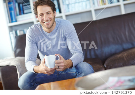 Portrait, home and man with coffee, relax and sitting on sofa, happiness and wellness with weekend break. Person, apartment and guy with morning tea in living room, espresso and smile with cappuccino Portrait, home and man with coffee, relax and sitting on sofa, happiness and wellness with weekend break. Person, apartment and guy with morning tea in living room, espresso and smile with cappuccino 142791370