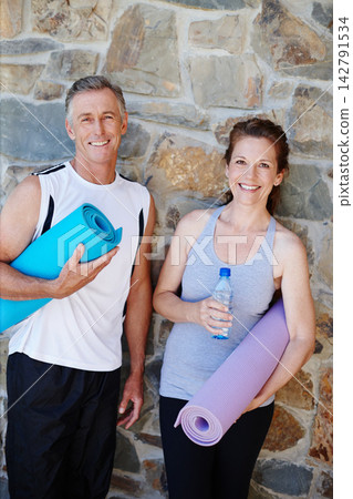 Happy couple, portrait or mat for yoga, fitness or support for pilates, workout or exercise by brick wall. Mature, gym or proud people with smile, teamwork or healthy wellness for training for class Happy couple, portrait or mat for yoga, fitness or support for pilates, workout or exercise by brick wall. Mature, gym or proud people with smile, teamwork or healthy wellness for training for class 142791534