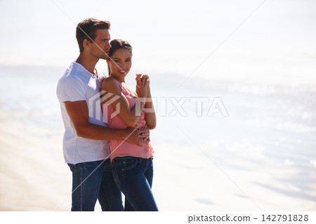 Happy couple, beach and hug in relax with love for embrace, care or support on outdoor holiday or vacation in nature. Man and woman with smile for relationship or weekend by the ocean on mockup space 142791828