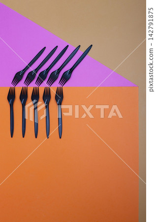 Geometric still life with black forks on a colored background Geometric still life with black forks on a colored background 142791875