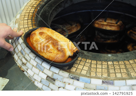 Freshly baked bread taken from a traditional oven in a bakery Freshly baked bread taken from a traditional oven in a bakery 142791925