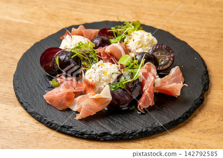 火腿的鹹味、乳清乾酪的甜味和水果的甜味完美融合,成就了一道風味平衡的佳餚。 火腿的鹹味、乳清乾酪的甜味和水果的甜味完美融合,成就了一道風味平衡的佳餚。 142792585