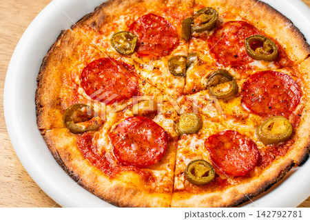 A savory pizza topped with spicy pepperoni A savory pizza topped with spicy pepperoni 142792781