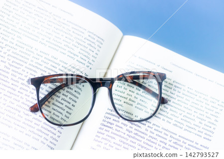 Reading - foreign books and magnifying glasses that make the text appear larger. Reading - foreign books and magnifying glasses that make the text appear larger. 142793527