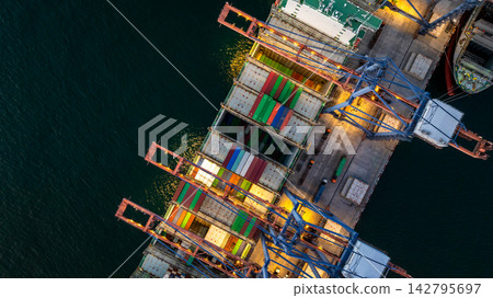 Aerial view container cargo ship loading unloading at night, Container cargo ship import export sea port, Global trade business container cargo ship freight shipping commercial trade logistic Aerial view container cargo ship loading unloading at night, Container cargo ship import export sea port, Global trade business container cargo ship freight shipping commercial trade logistic 142795697
