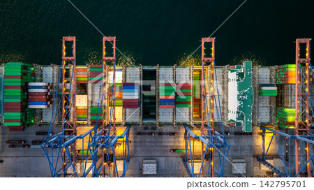 Aerial view container cargo ship loading unloading at night, Container cargo ship import export sea port, Global trade business container cargo ship freight shipping commercial trade logistic Aerial view container cargo ship loading unloading at night, Container cargo ship import export sea port, Global trade business container cargo ship freight shipping commercial trade logistic 142795701