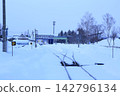 A local train running through a snow-covered plain, in winter in Hokkaido. 142796134