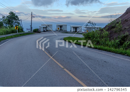 Winding downhill road at  Thailand, photographed from the driver's perspective while driving. 142796345