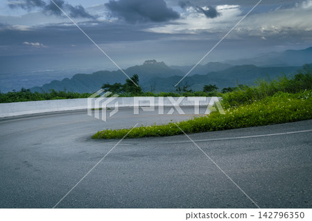 Winding downhill road at Thailand, photographed from the driver's perspective while driving. 142796350