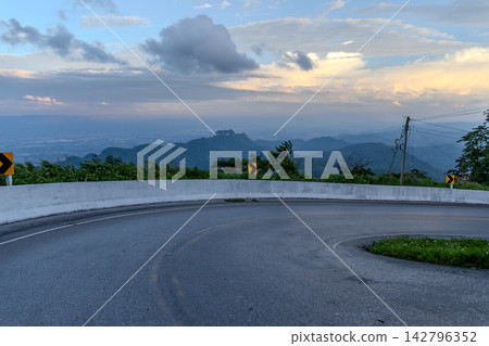 Winding downhill road at Thailand, photographed from the driver's perspective while driving. Winding downhill road at Thailand, photographed from the driver's perspective while driving. 142796352